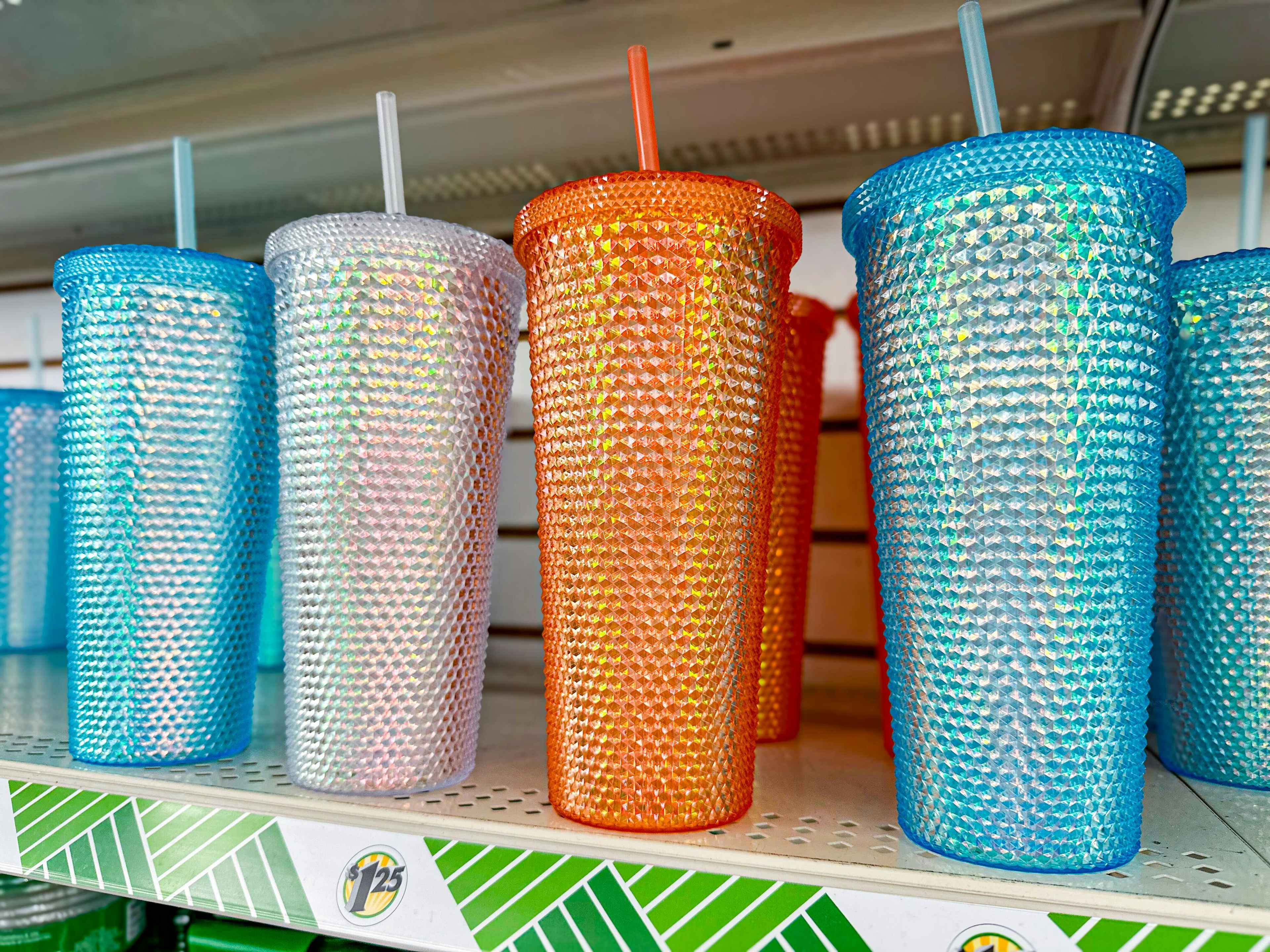 blue, white, and orange studded tumblers on a shelf at dollar tree