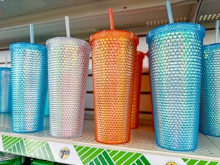 blue, white, and orange studded tumblers on a shelf at dollar tree