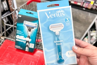 Handing holding gillette venus razor inside a Cvs