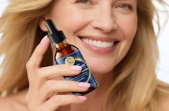 a person holding collagen drop in a bottle