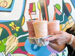 woman holding smoothies