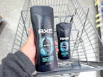 hand holding axe body wash and one axe body wash in walgreens cart