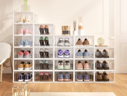shoes in clear storage boxes stacked against a wall