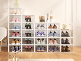 shoes in clear storage boxes stacked against a wall
