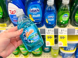 hand holding gain small dish soap next to sale tags
