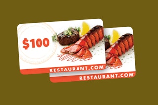 A photo of two restaurant gift cards on a green background