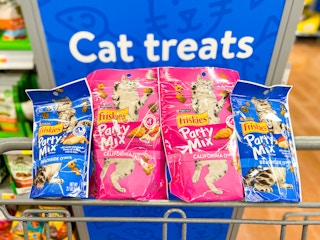 Showing four bags of Friskies cat treats in front of the "Cat treats" sign