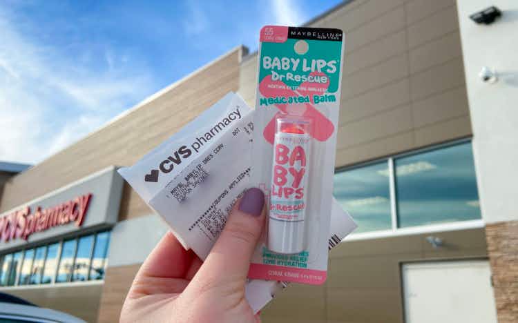 CVS receipt being held with Baby Lips lip balm outside a CVS store