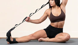 a person using a stretching strap to stretch their calf