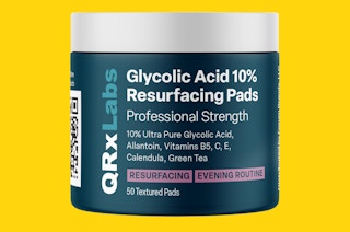 a green jar of face cleansing pads