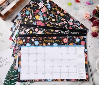 floral desk calendars piled on a table