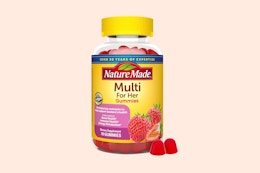 nature made multi gummies on a light pink background