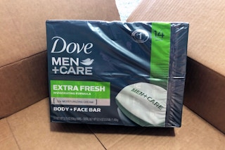 A package of Dove Men+Care soap in an open Amazon delivery box.
