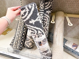 hand grabbing a threshold runner off a target shelf