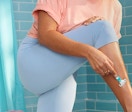 A woman shaving her legs with a Venus Simply 3 Razor.