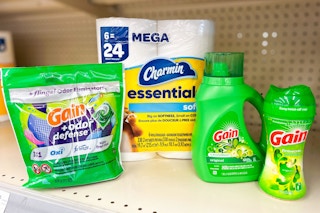 three gain laundry products and pack of charmin toilet paper on store shelf