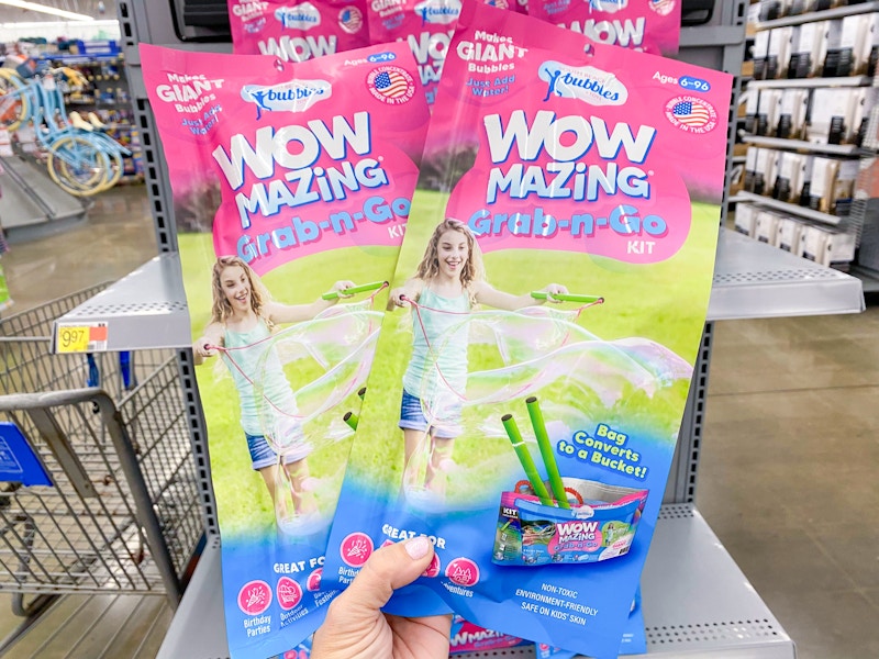 hand holding two wowmazing giant bubble kits at walmart