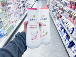 hand holding two bottles of dove body wash