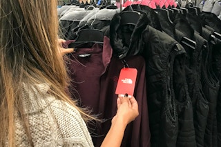 person looking at north face apparel in macys store