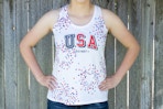 A person wearing a white Old Navy USA tank top with stars stenciled on in red and blue.