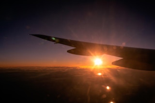 Sunset over airplane wing