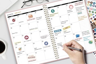 a pink planner with sticker sheets