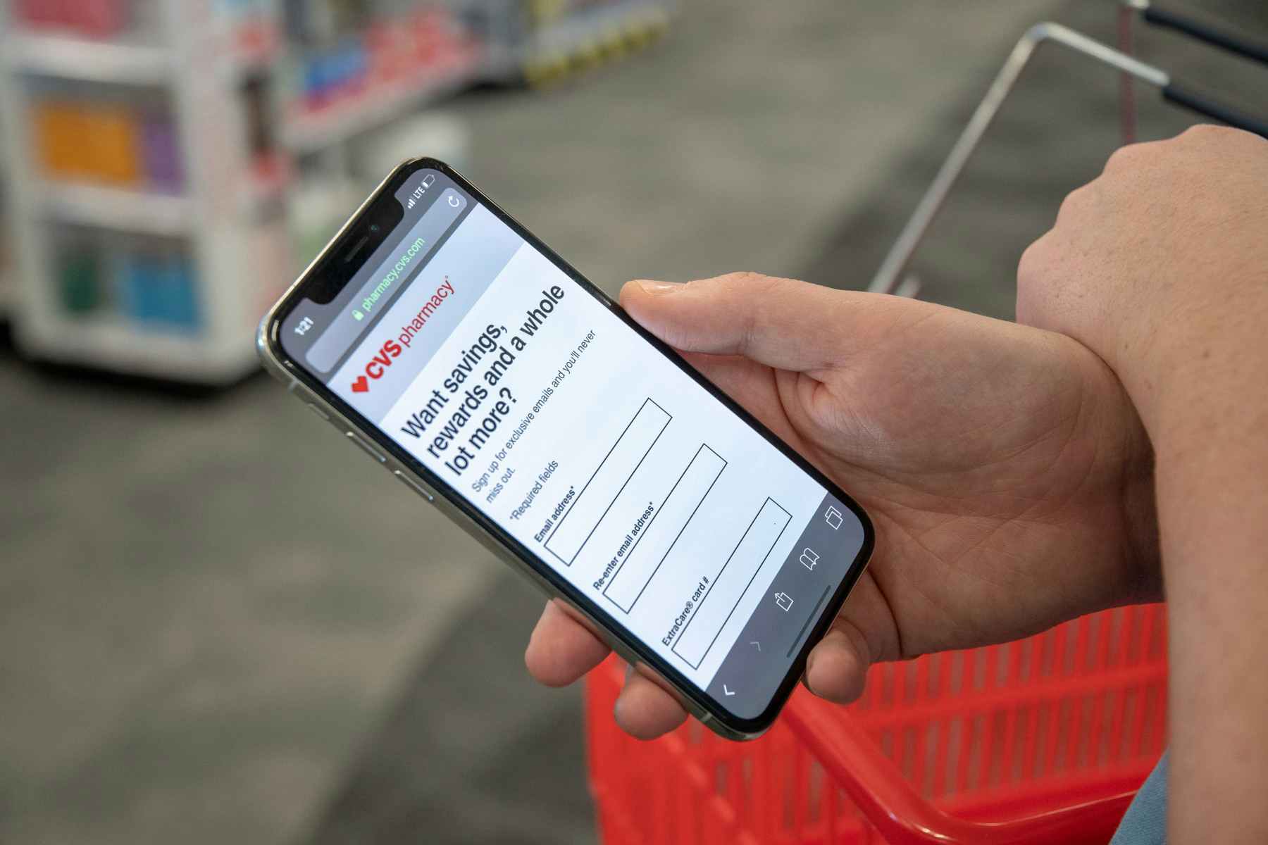 Someone holding their phone displaying the CVS email sign up page