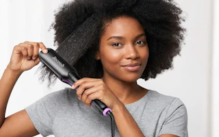 a person using a hair straightener