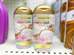 2 bottles of ogx miracle oil sitting on a target shelf