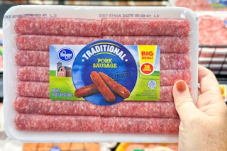 hand holding a pack of kroger sausage links