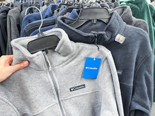 academy columbia jackets being held up