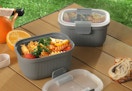 gray bento containers on a picnic table