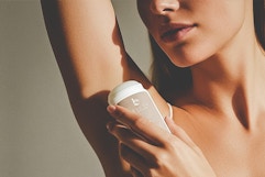 a woman using beauty by earth deodorant