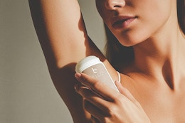 a woman using beauty by earth deodorant