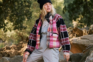 a woman outside wearing a free people hiking onesie