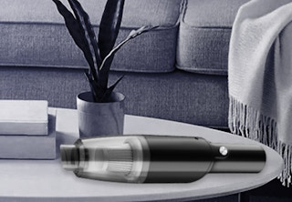 a mini vacuum on a table next to a sofa