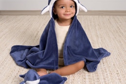 a baby wearing a gerber blanket