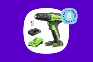 a green cordless drill and battery