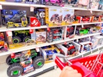 target cart parked in front of monster jam toys sitting on a target shelf