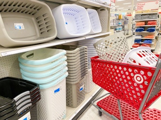 laundry basket and hamper in a target cart in front of a laundry baskets and hampers on a target shelf