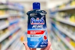 hand holding a finish jet dry rinse aid in a target aisle