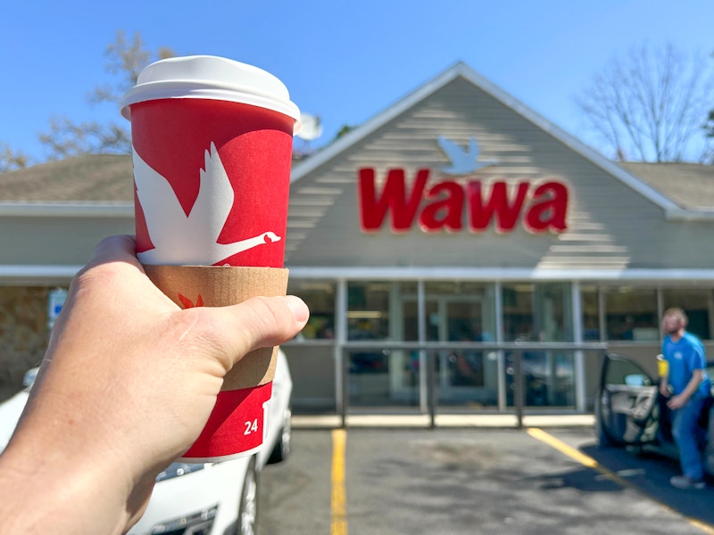 Someone holding a coffee outside of a Wawa