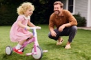 father watching child ride their bike