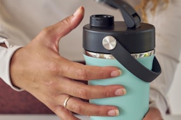 a woman using a hydro flask shaker