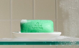 a green bar of soap on a soap dish