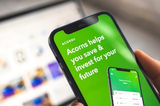 Someone looking at the Acorns app on their phone