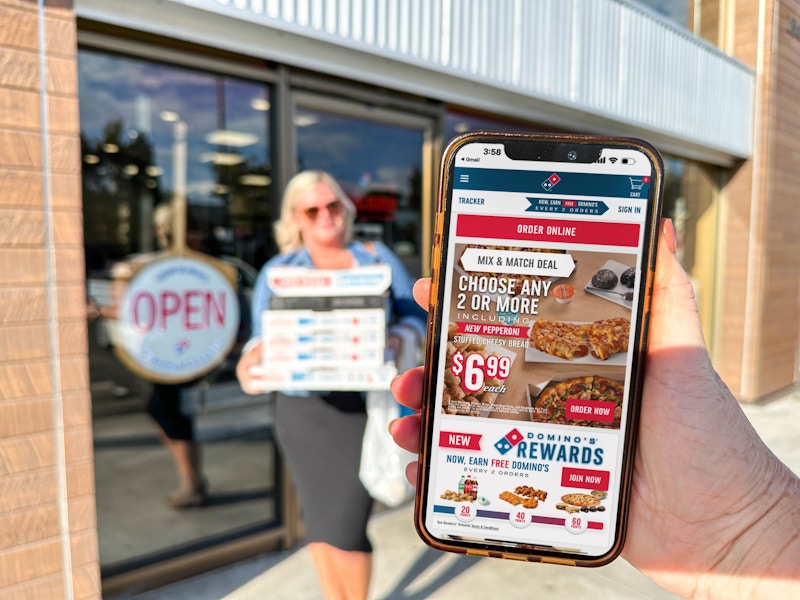 a cellphone with dominos special on the scree in front of dominos 