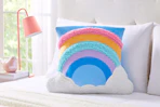 Lifestyle image of a rainbow snuggly pillow from the brand Your Zone at Walmart