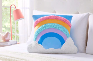 Lifestyle image of a rainbow snuggly pillow from the brand Your Zone at Walmart