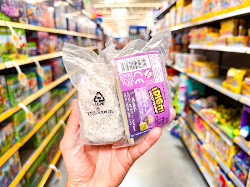 hand holding excavation egg kit in walmart aisle